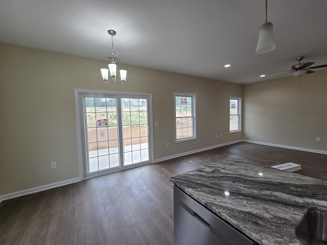 interior space featuring dark wood-style floors, baseboards, ceiling fan with notable chandelier, and recessed lighting