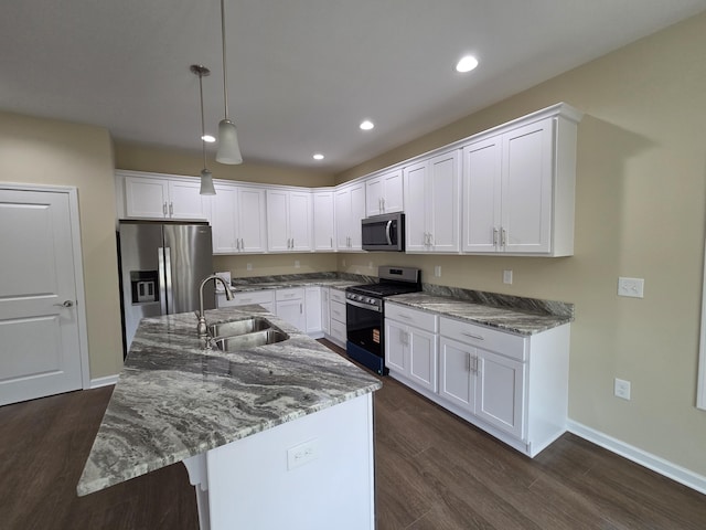kitchen with dark wood-style floors, a sink, white cabinets, and appliances with stainless steel finishes