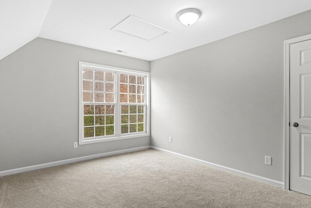 spare room featuring lofted ceiling and carpet floors