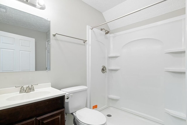 bathroom with walk in shower, vanity, toilet, and a textured ceiling