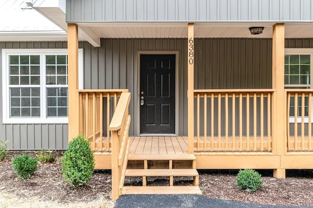 view of exterior entry with a porch