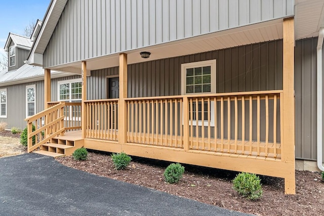 view of exterior entry featuring covered porch