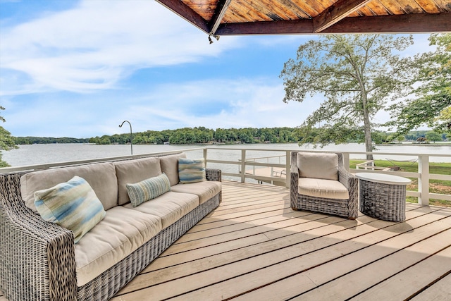 wooden deck featuring a water view and an outdoor living space