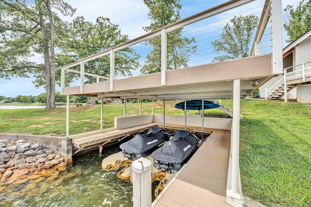 view of dock with a water view and a lawn