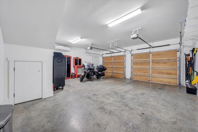 garage with a garage door opener and an AC wall unit