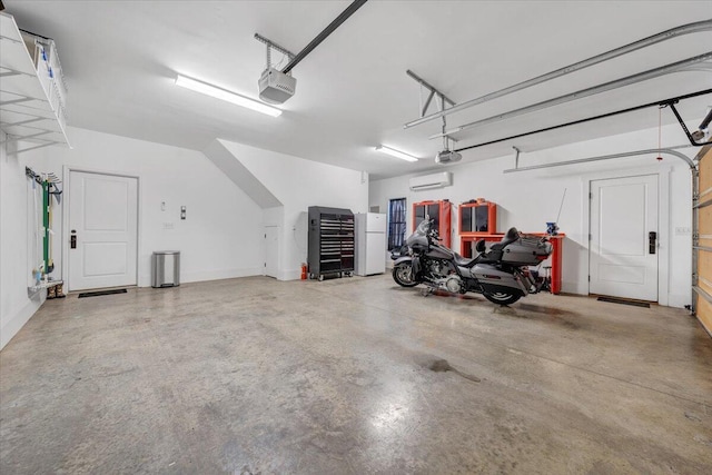 garage featuring a wall unit AC, freestanding refrigerator, and a garage door opener