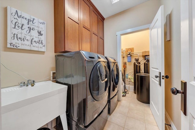 washroom with cabinet space, a sink, and separate washer and dryer