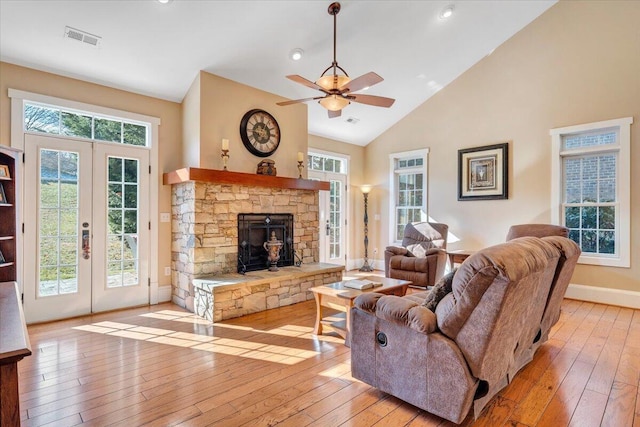 living area with light wood-type flooring, french doors, visible vents, and plenty of natural light