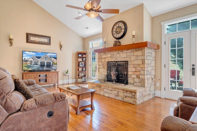 living room with french doors, light wood-style floors, ceiling fan, high vaulted ceiling, and baseboards