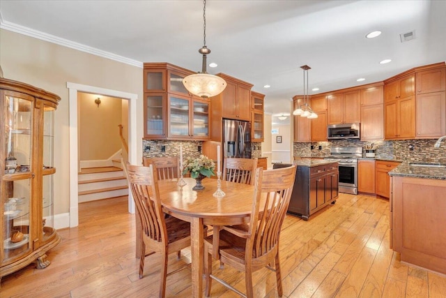 dining room with visible vents, light wood-style flooring, stairway, ornamental molding, and recessed lighting