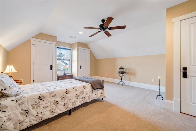 bedroom with ceiling fan, carpet, baseboards, and vaulted ceiling