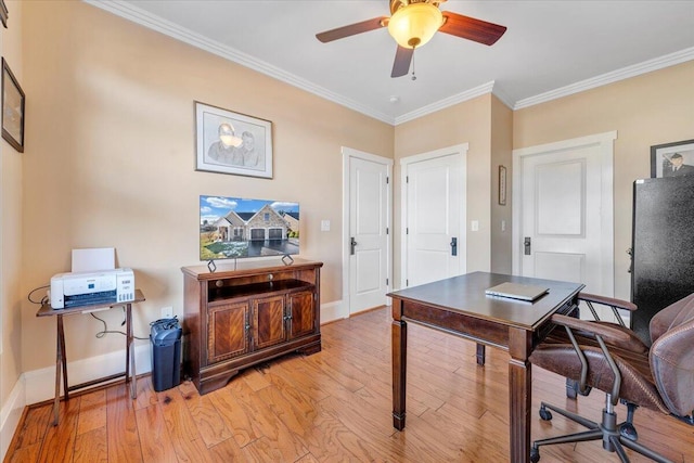 office with baseboards, light wood-style flooring, and crown molding