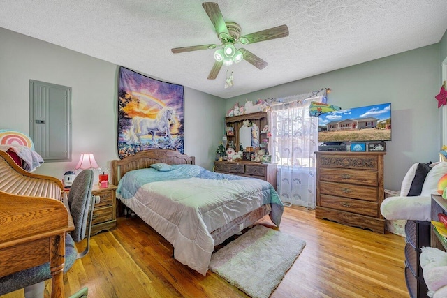 bedroom featuring ceiling fan, a textured ceiling, and hardwood / wood-style floors