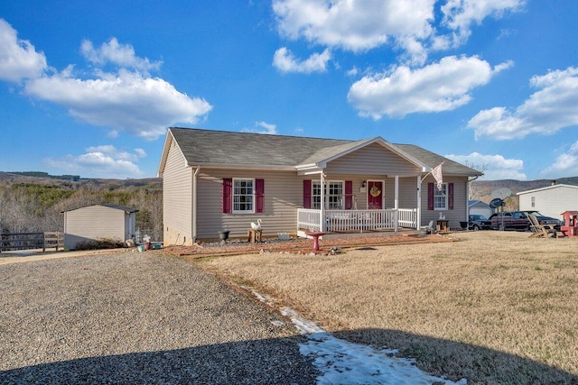 ranch-style home featuring a front yard and covered porch