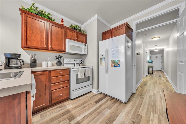 kitchen with sink, white appliances, crown molding, and light wood-type flooring