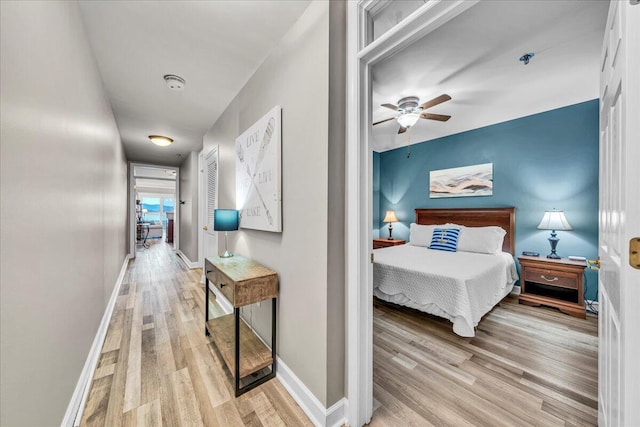 bedroom with ceiling fan and light hardwood / wood-style flooring