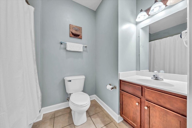 bathroom with toilet, vanity, and tile patterned flooring