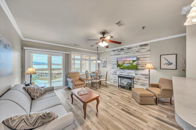 living room featuring light hardwood / wood-style floors and ornamental molding