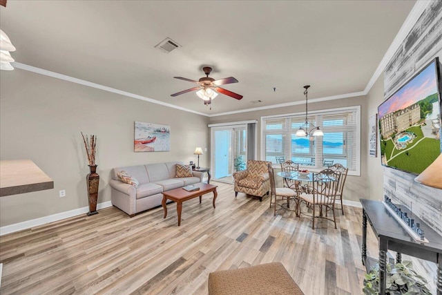 living room with ceiling fan with notable chandelier, crown molding, and light hardwood / wood-style floors