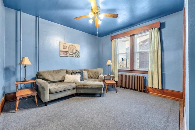 living room with ceiling fan, radiator heating unit, and carpet flooring