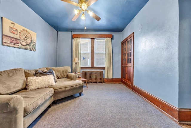 living room with radiator heating unit, carpet flooring, and ceiling fan