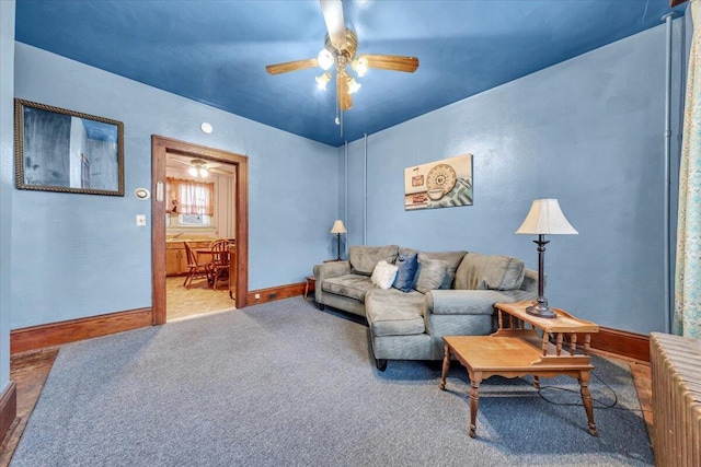 carpeted living room with ceiling fan