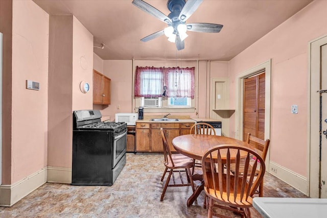 kitchen with sink, ceiling fan, and stainless steel gas stove