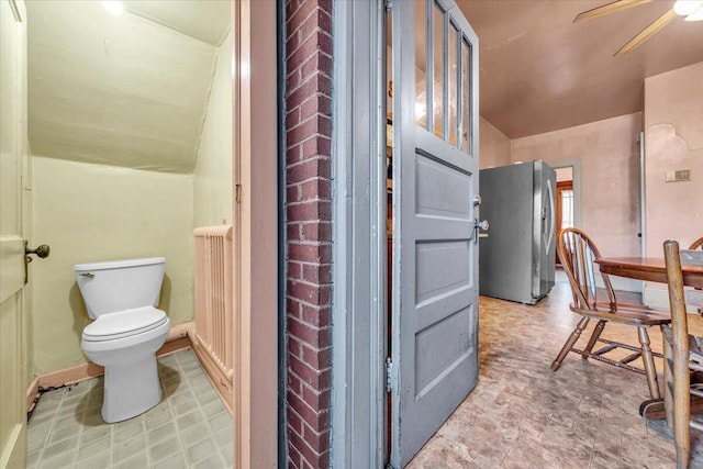 bathroom featuring toilet and ceiling fan