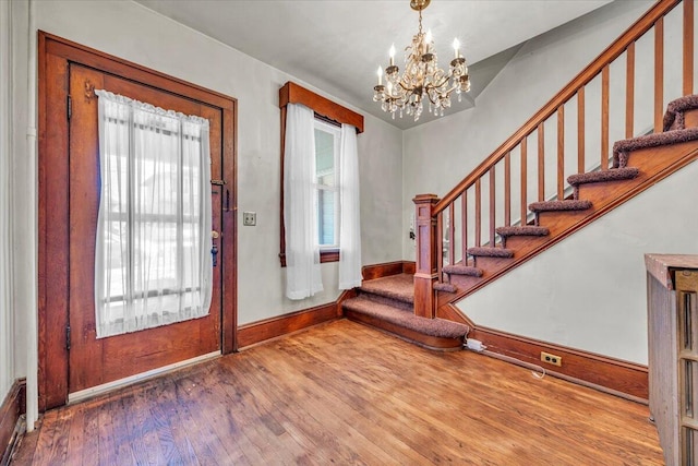 foyer featuring hardwood / wood-style flooring and a notable chandelier