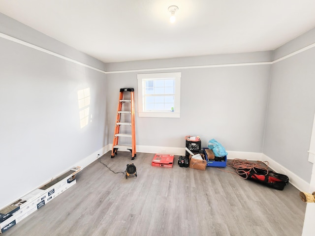 interior space with wood finished floors and baseboards