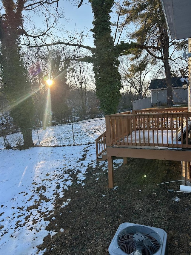 yard covered in snow featuring cooling unit and a wooden deck