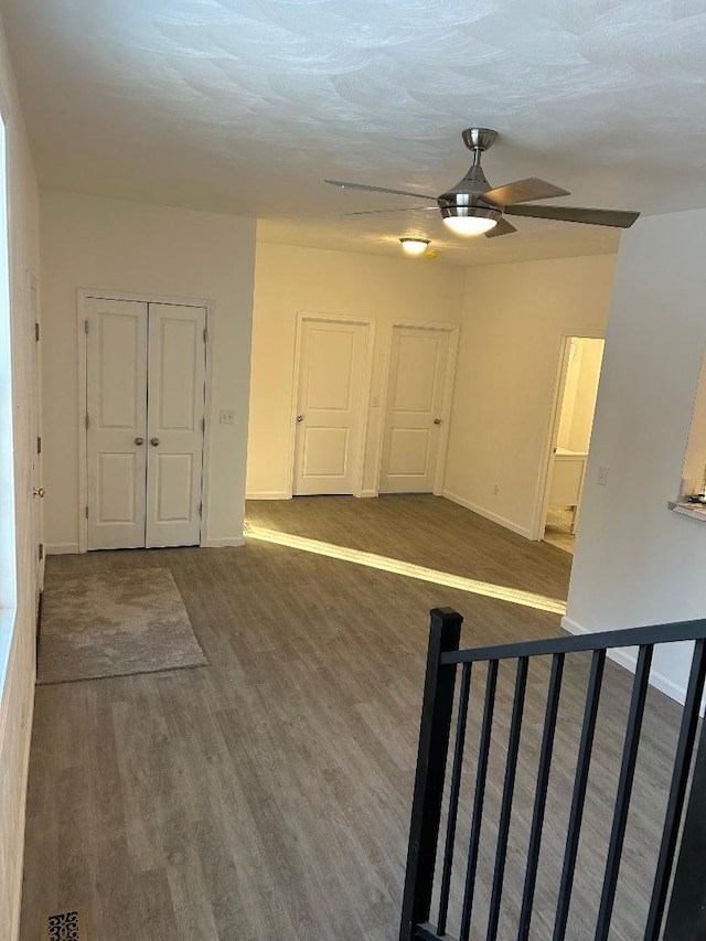 spare room with ceiling fan and dark hardwood / wood-style flooring