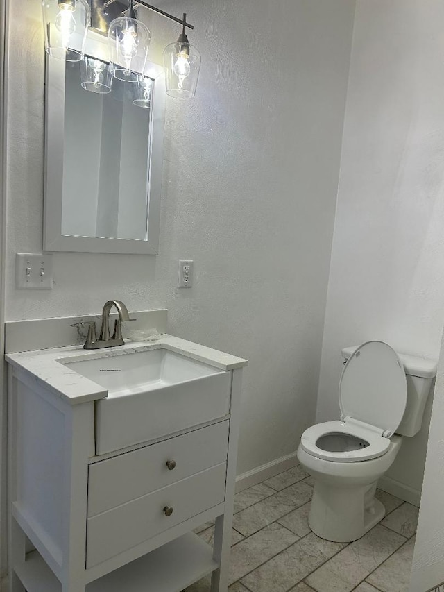 bathroom featuring toilet and vanity