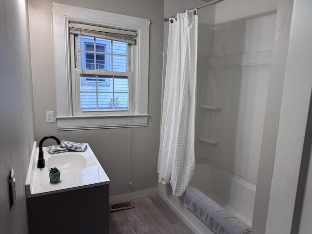 bathroom featuring shower / bath combo, hardwood / wood-style floors, and vanity