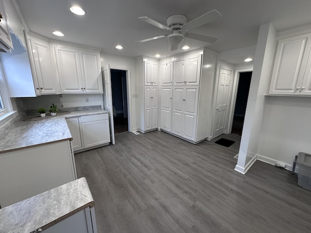 kitchen with ceiling fan, white cabinetry, and hardwood / wood-style floors