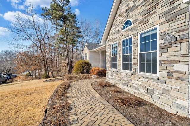 view of side of home featuring a yard