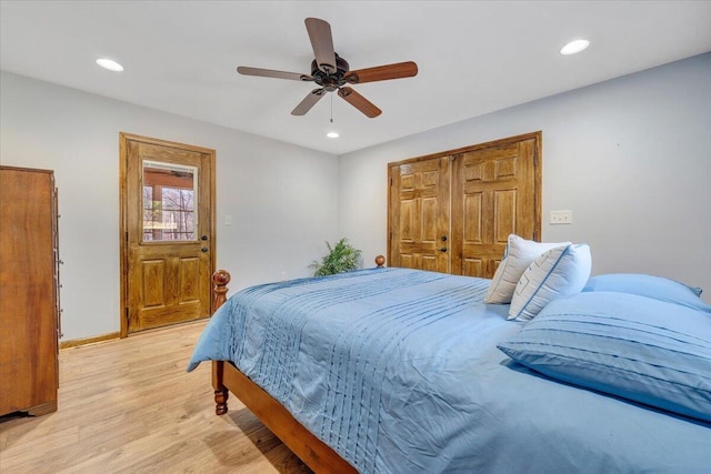 bedroom with a closet, ceiling fan, and light hardwood / wood-style flooring