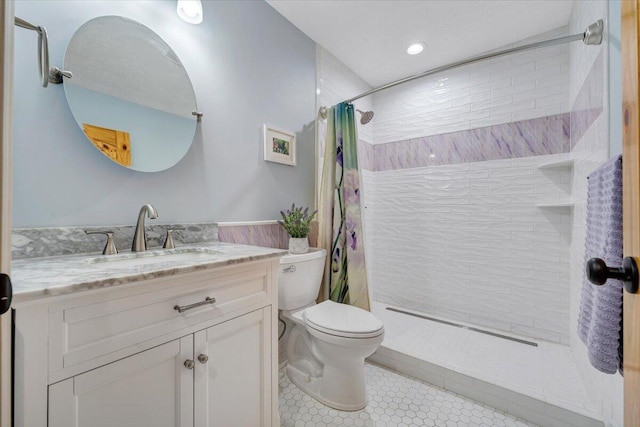 bathroom with tile patterned floors, toilet, vanity, and a shower with curtain