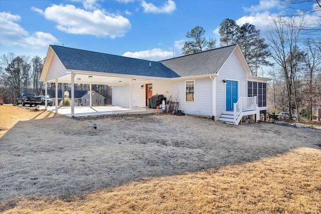 back of property with a patio and a sunroom