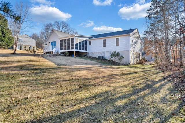 rear view of property with cooling unit, a yard, and a sunroom