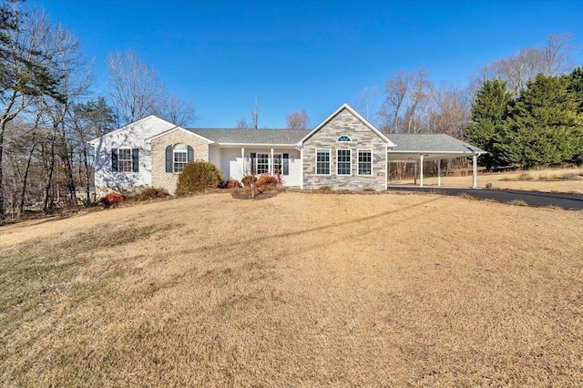 single story home featuring a front yard and a carport