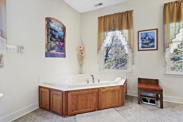 bathroom featuring tile patterned floors and a tub