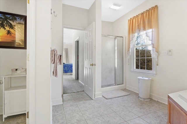 bathroom featuring tile patterned flooring, vanity, and an enclosed shower