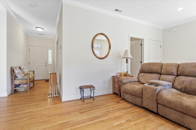 living room featuring ornamental molding and light hardwood / wood-style floors