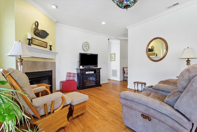 living room featuring ornamental molding and light wood-type flooring