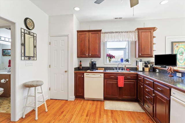 kitchen with ceiling fan, sink, white dishwasher, and light hardwood / wood-style floors