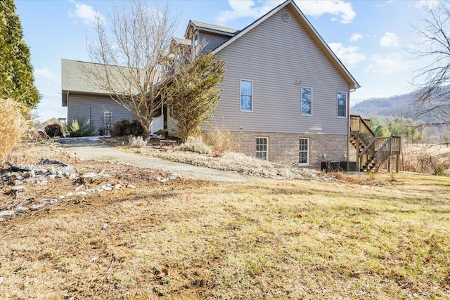 rear view of house featuring a lawn