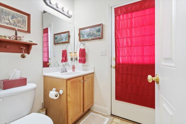 bathroom featuring vanity and toilet