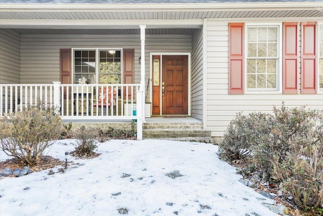 view of snow covered property entrance