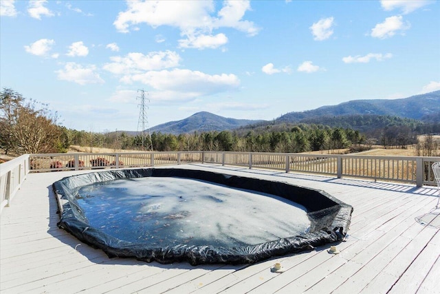 view of pool featuring a deck with mountain view